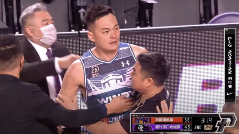 台灣職籃 Plus league 上週有球員在場上發生衝突，吳岱豪（畫面中）在被洋將羅賓森犯規後，生氣的用球砸向對方，被裁判和教練團架開，避免衝突延燒。取自網路影片